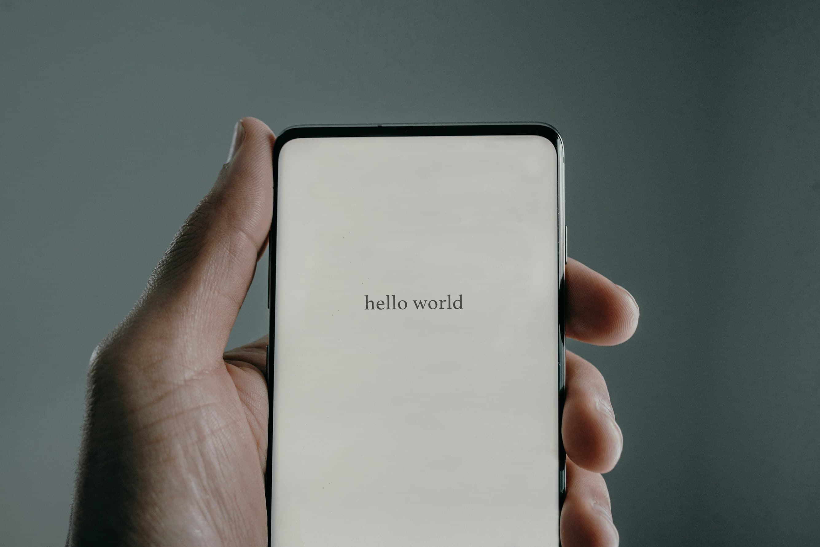 A smartphone displaying the words hello world